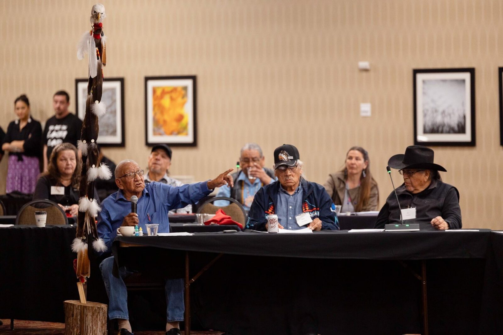 people speaking and listening at a meeting