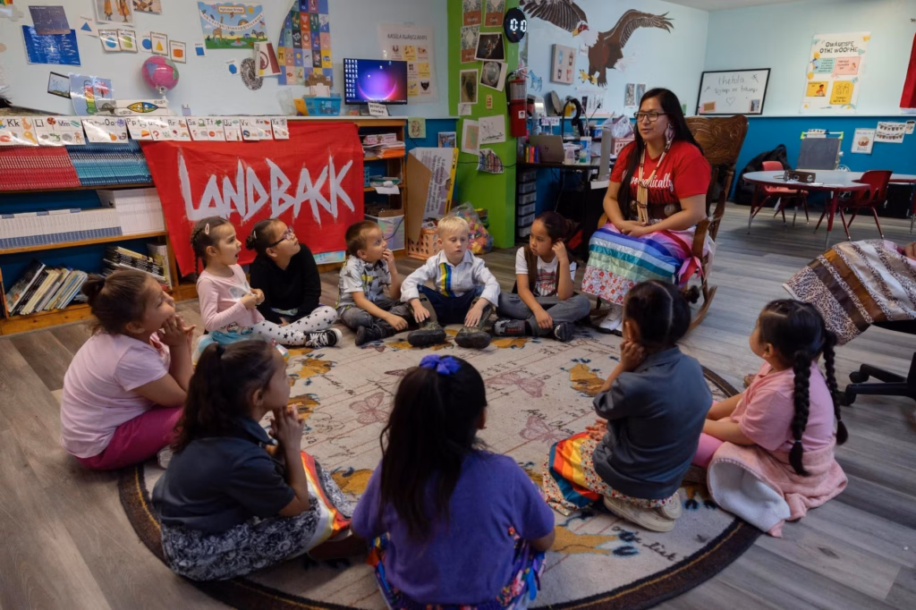 woman in a classroom with a circle of engaged children